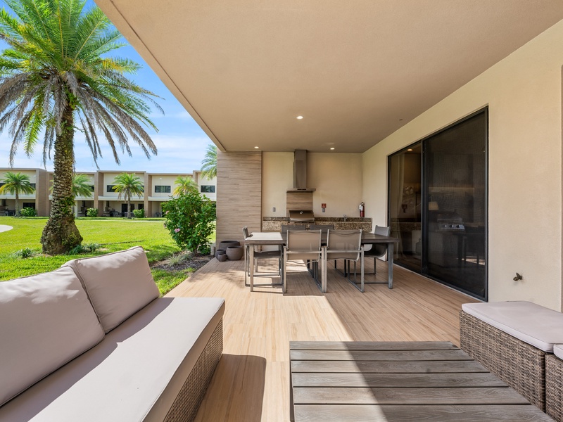 Relax in style with a cozy outdoor living area, with BBQ grill, perfect for family cookouts and evening gatherings under the Florida sky.