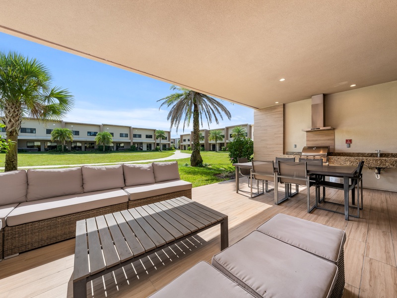 Relax in style with a cozy outdoor living area, with BBQ grill, perfect for family cookouts and evening gatherings under the Florida sky.
