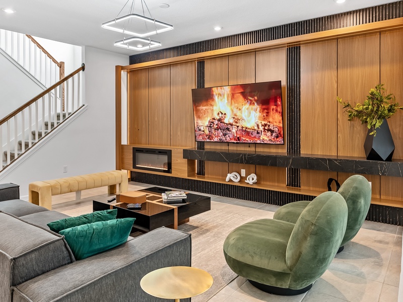 Enjoy cozy movie nights by the fireplace with comfortable seating.