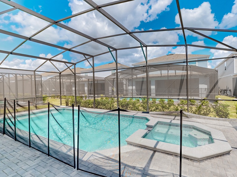 Pool area with attached spa & child safety fence