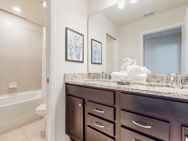 2nd floor shared bathroom located in the center of the home between the Princess bunkbed room and additional bedroom. Shower with tub.