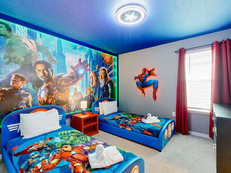 2nd floor Avengers kids bedroom with 2 twin beds that are close to the floor.  Room has a TV and a private ensuite.  Located to the left at the top of the stairs.