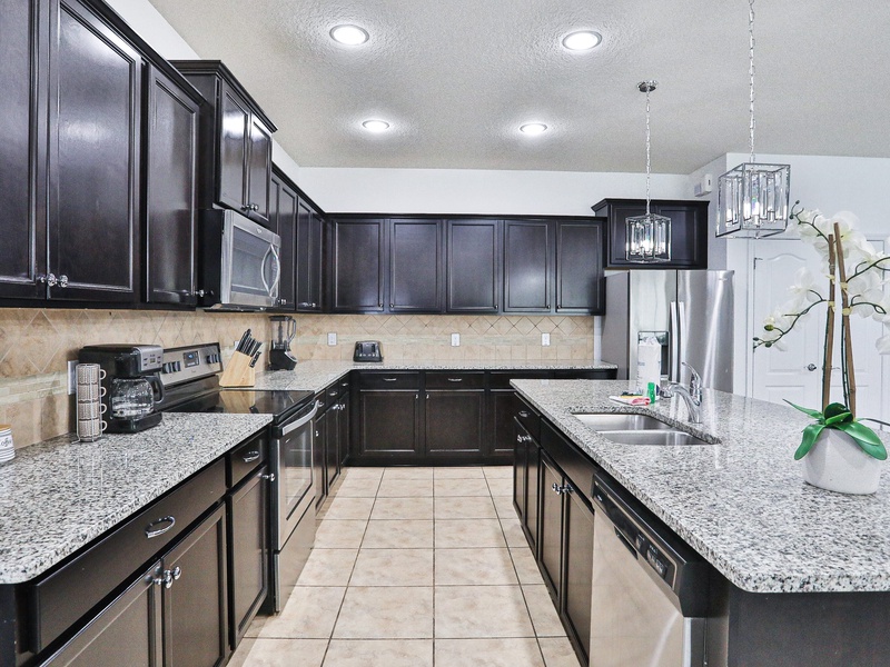Fully equipped kitchen with stainless steel appliances.