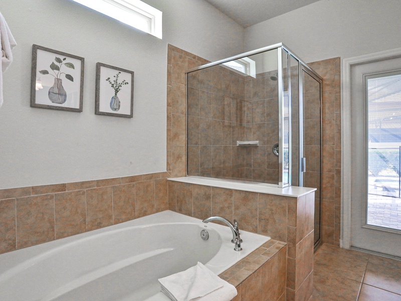 Bedroom #2 - private ensuite with double sink vanity, soaking tub, walk in shower, toilet closet, and access to lanai.