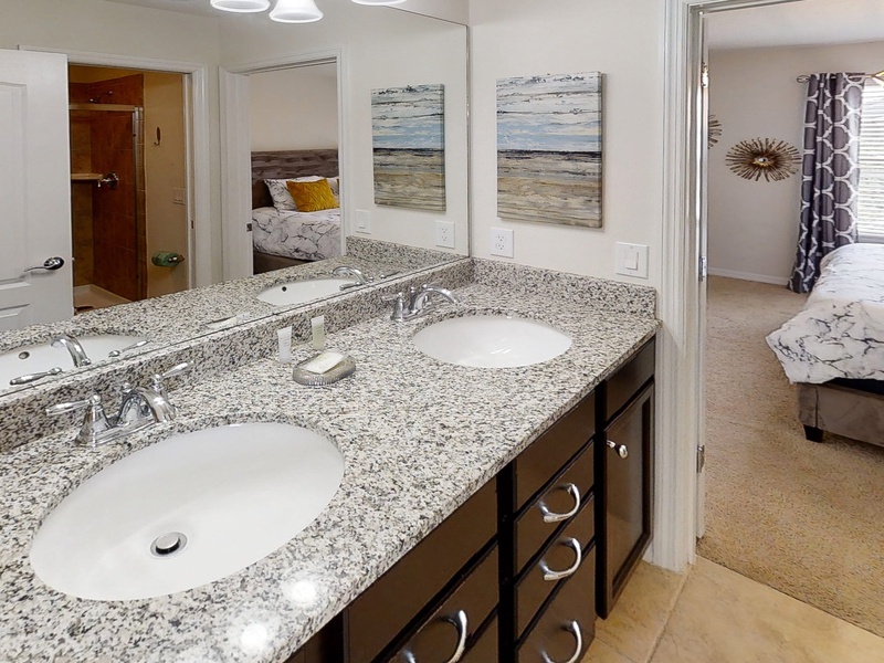 Jack and Jill bathroom between Bedroom #3 & Bedroom #4 with double sink vanity, toilet & walk in shower