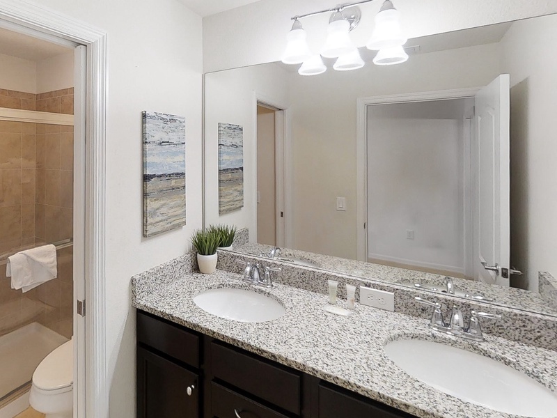2nd floor shared bathroom between Bedroom #6 & Bedroom #7 with double sink vanity, toilet & walk in shower