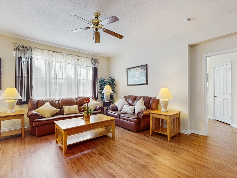 Main living room area with ceiling fan & TV
