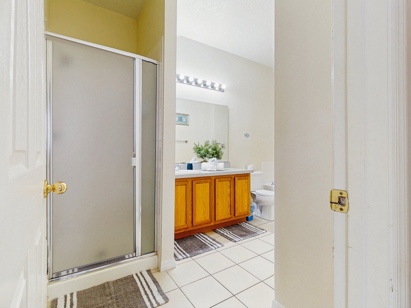 Bedroom #4 private ensuite with single sink extended vanity, soaking tub, walk in shower & toilet.