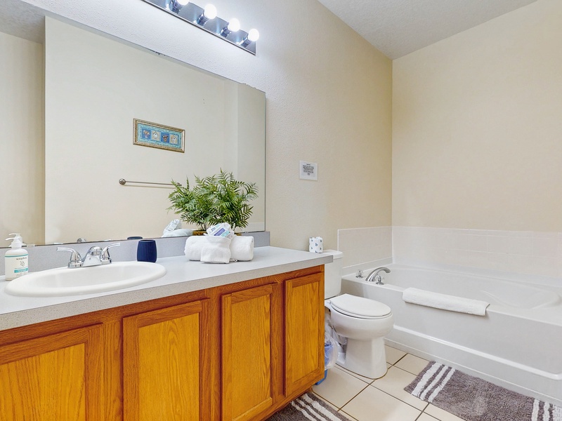 Bedroom #4 private ensuite with single sink extended vanity, soaking tub, walk in shower & toilet.