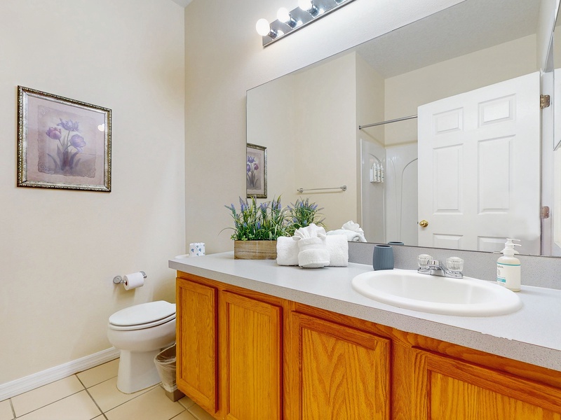 Shared hallway bathroom in center of home with single sink extended vanity, shower/tub combo & toilet.  Children's training potty & step stool available.