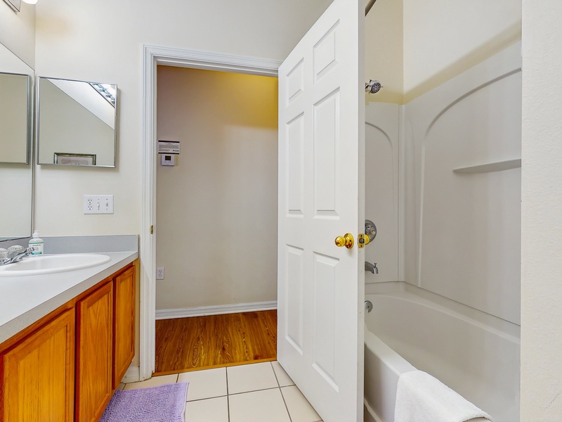 Shared hallway bathroom in center of home with single sink extended vanity, shower/tub combo & toilet.  Children's training potty & step stool available.