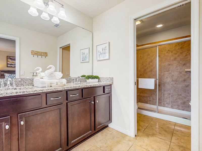Bedroom #2 - private ensuite with a double sink vanity, toilet & walk in shower