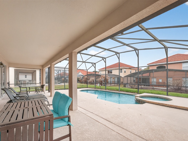 Relax on the private patio featuring a pool and comfortable seating area.