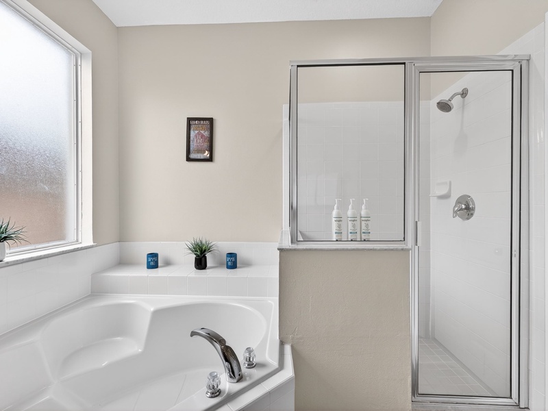 Unwind in the master bathroom, featuring a separate shower and soaking tub.