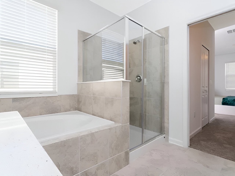 Spacious master bathroom with shower, bathtub and double vanity.