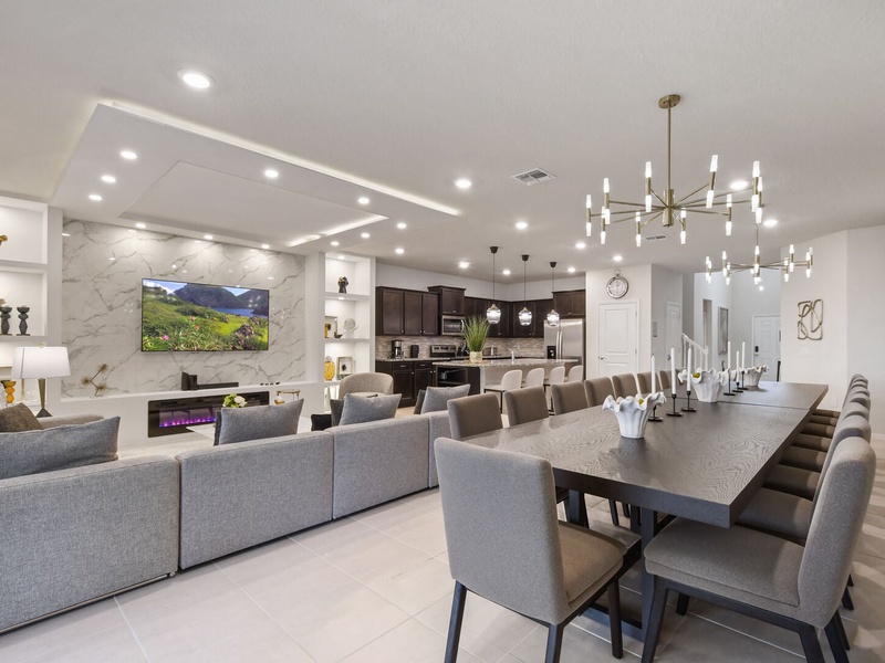 Gather in this beautifully designed living area, complete with a huge sectional sofa, an indoor fireplace, an oversized dining table, and a fully equipped kitchen. Perfect for making memories together.
