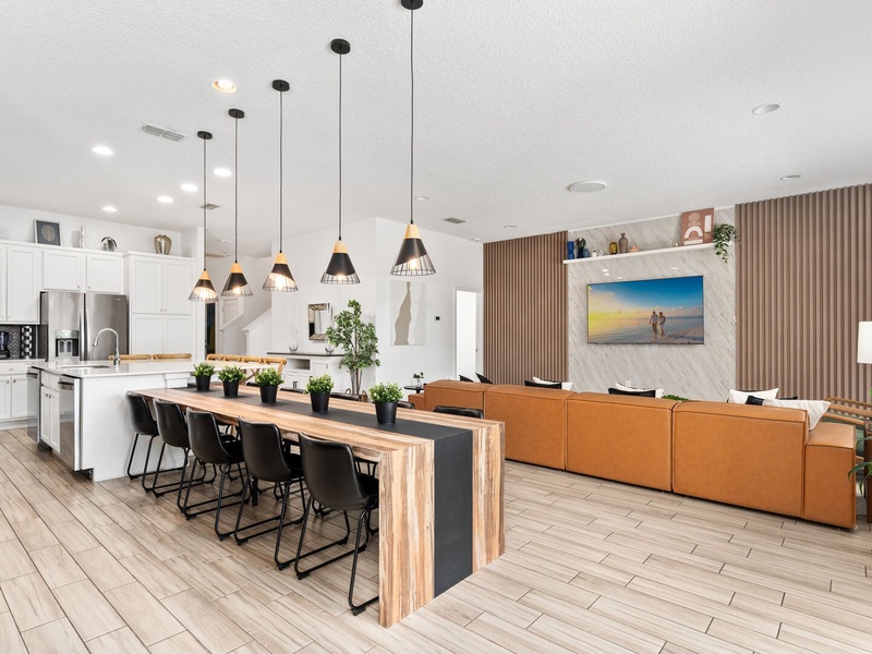 The living room, dining area, and kitchen seamlessly blend into one cohesive space.