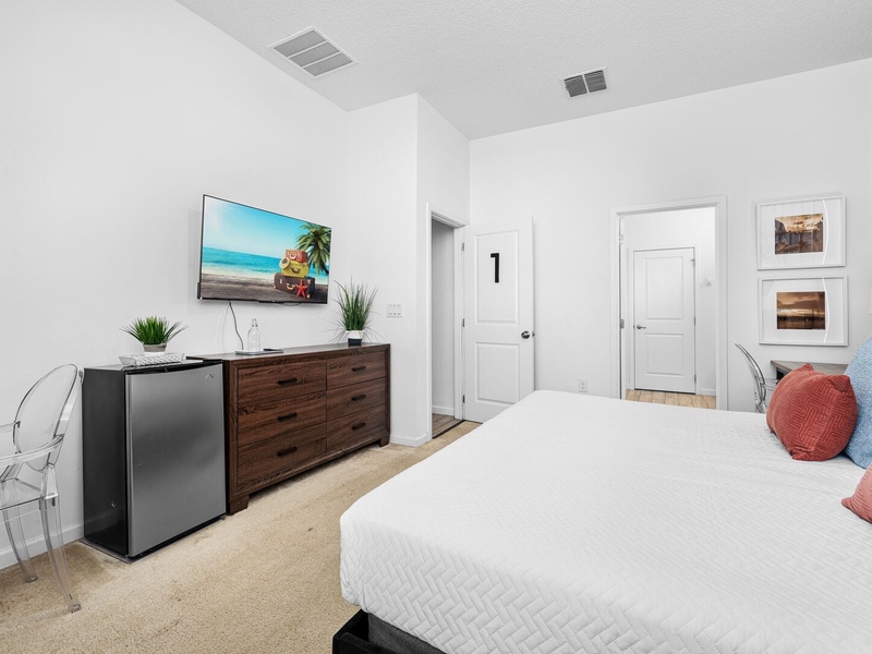 Our first bedroom features a king size bed, its own working space, mini fridge, TV and full private bathroom.