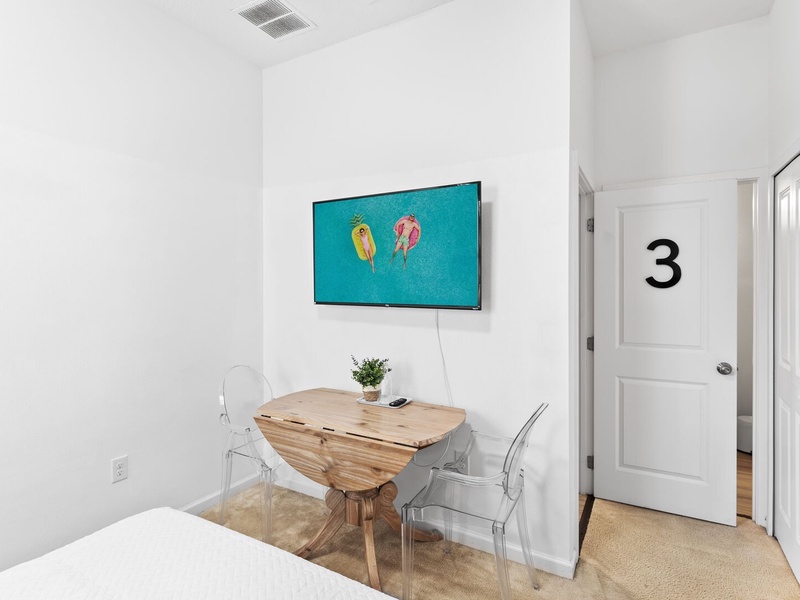 Our third bedroom features a queen size bed, its own working space, TV and full private bathroom.
