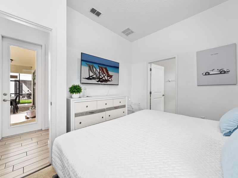 Our fourth bedroom features a king size bed, access to the patio-pool area, TV and full private bathroom.