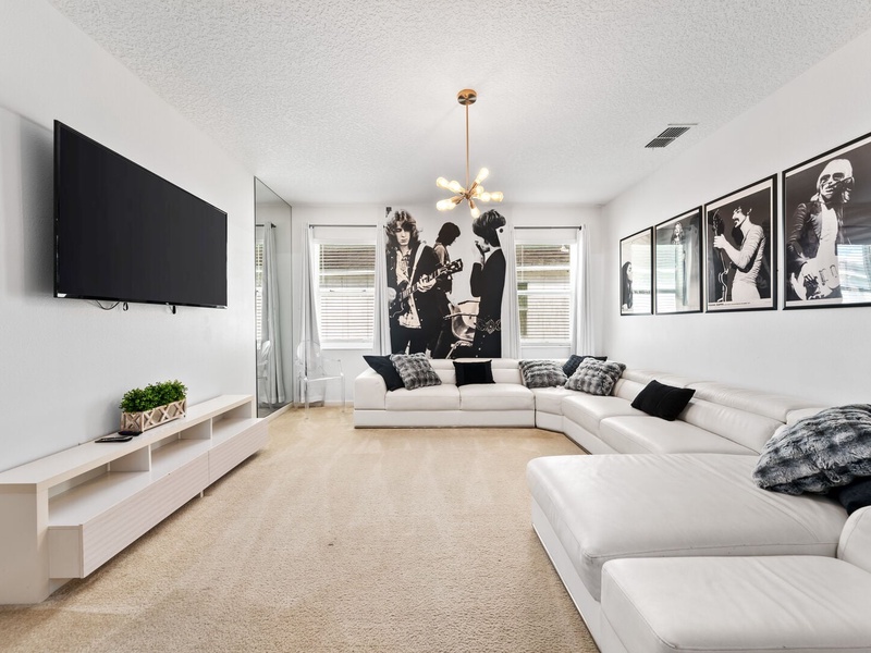 A stylish second TV room, featuring a large screen TV and a fun pool table for hours of enjoyment.