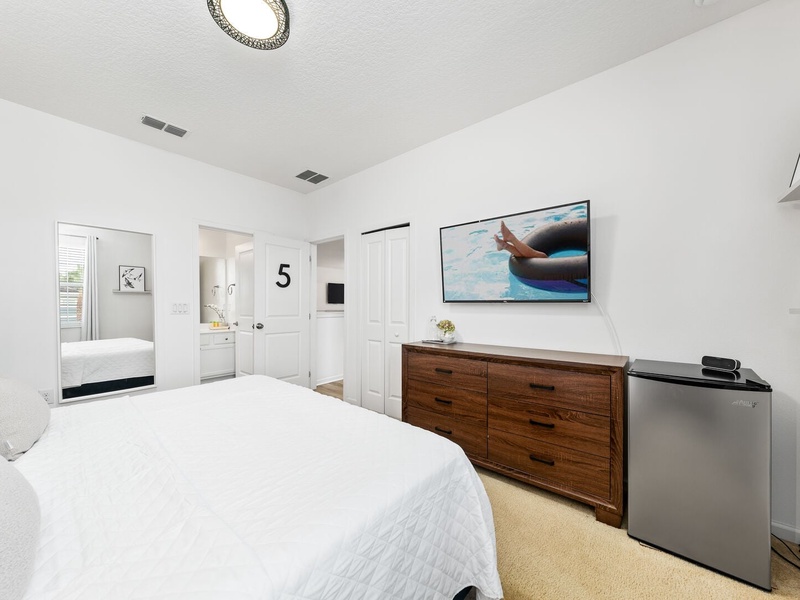 Our fifth guest room features a mini bar fridge, its own TV and full private bathroom.