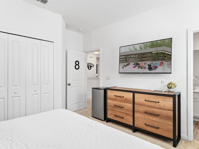 Our eighth bedroom features a mini bar fridge, TV, and a full private bathroom.