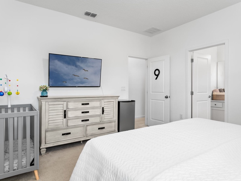 Our ninth bedroom includes a mini bar fridge, a TV, a full private bathroom, and a crib for your convenience.