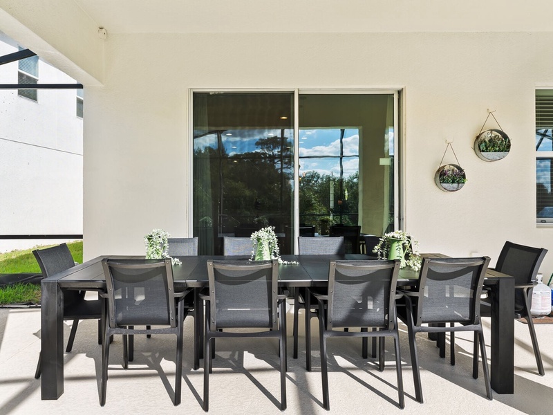 Enjoy al fresco dining at the outdoor table, complete with a BBQ grill, perfect for meals by the pool under the sun.