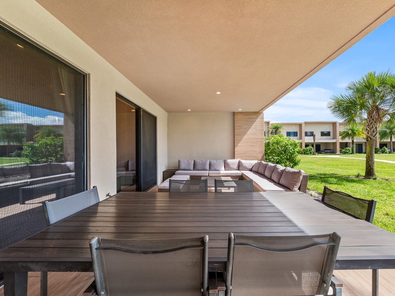Relax in style with a cozy outdoor living area, with BBQ grill, perfect for family cookouts and evening gatherings under the Florida sky.