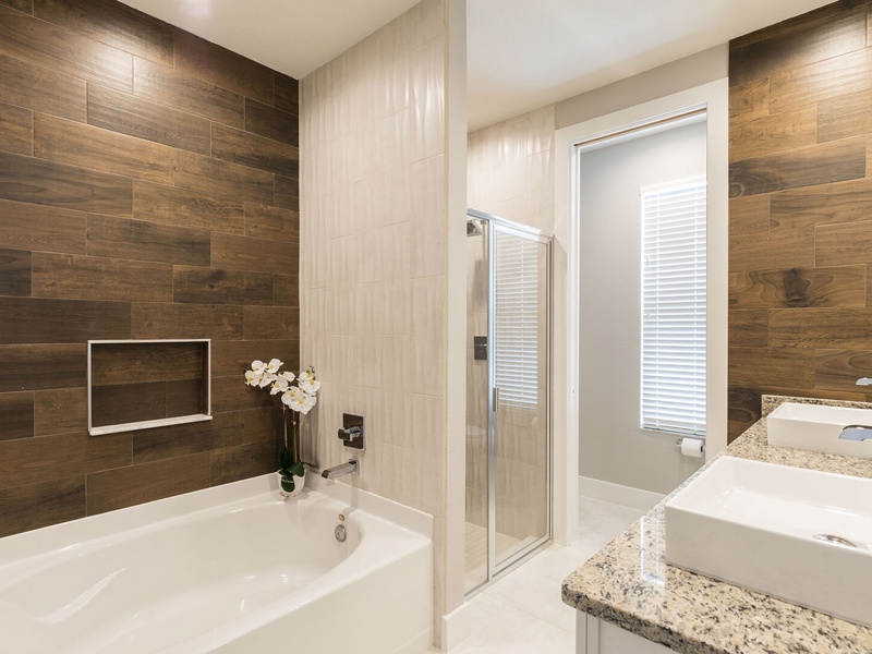 Our master bathroom features its own bath tub and shower for your convenience.