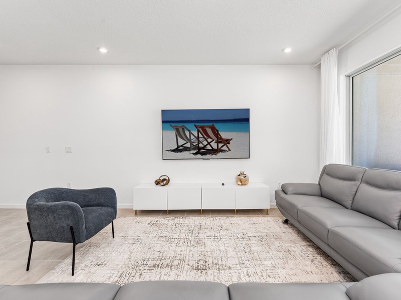 Enjoy a movie night in our cozy living room, complete with a large-screen TV and comfortable plush seating.