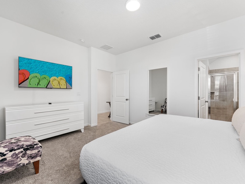 This room includes its own TV, ample closet space, and a private bathroom for your convenience.