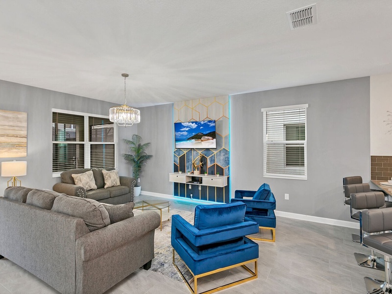Enjoy a movie night in our cozy living room, complete with a large-screen TV and comfortable plush seating.