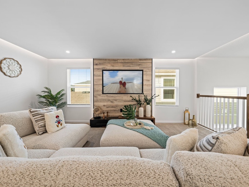 Enjoy a movie night in our cozy second living room, complete with a large-screen TV and comfortable plush seating.