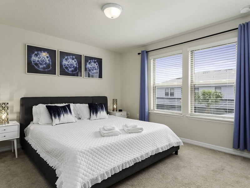 Guest bedroom featuring a king-size bed and full private bathroom.