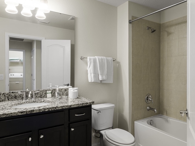 Full bathroom with combo tub shower, fresh towels and complimentary toiletries for your convenience.