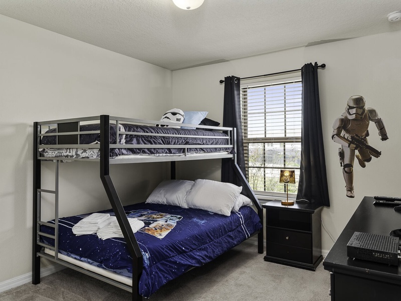 This guest room features a bunk bed with a double-size bed on the bottom and a twin-size bed on top.