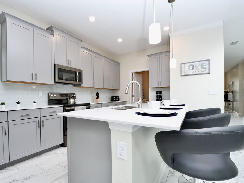 Fully equipped kitchen featuring sleek stainless steel appliances.