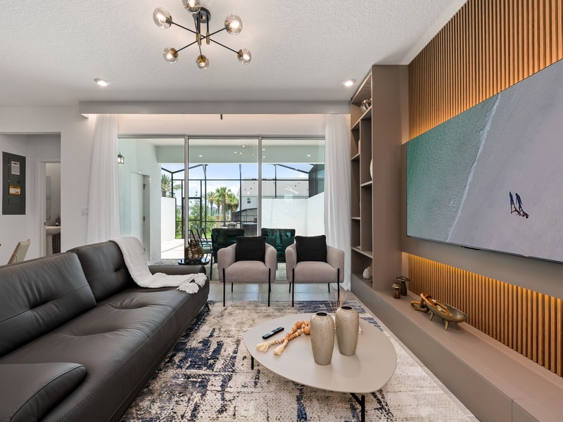 Enjoy a movie night in our cozy living room, complete with a large-screen TV and comfortable plush seating.