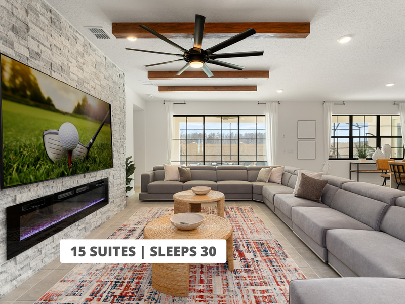 Sleek and spacious living room featuring modern furniture, indoor fireplace, and a large smart TV, perfect for relaxing or hosting a movie night in style.