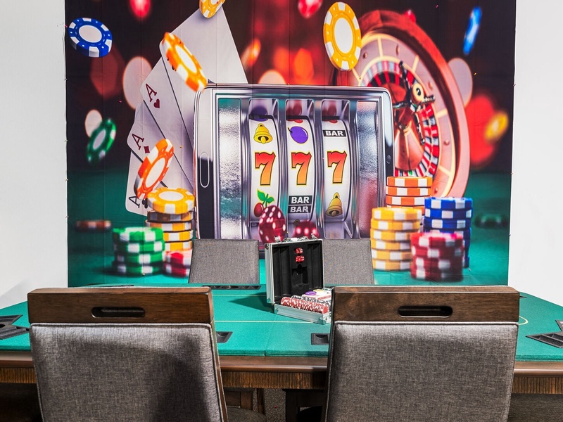 Game room with pool table, foosball table, and game consoles, perfect for family fun and entertainment