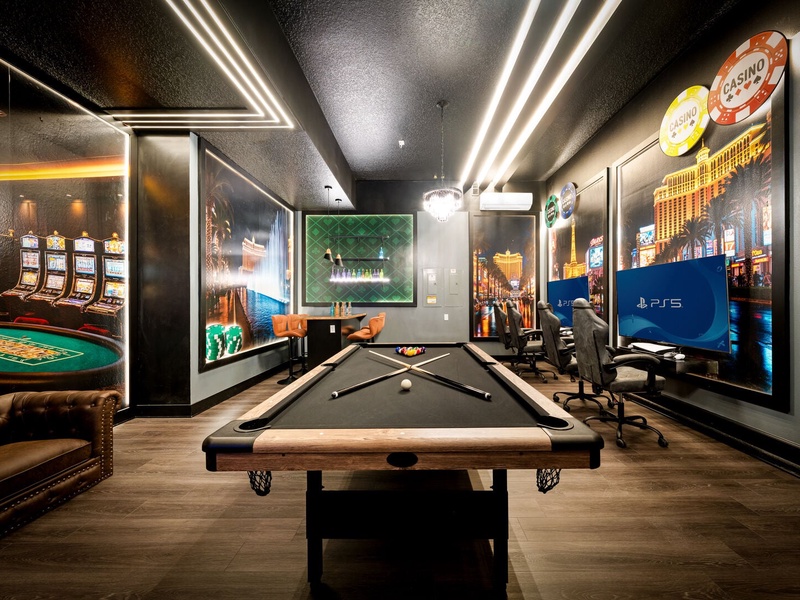 Viva las Vegas! Our Vegas-style game room features a game console, pool table, arcade games, and vibrant lounge vibe.
