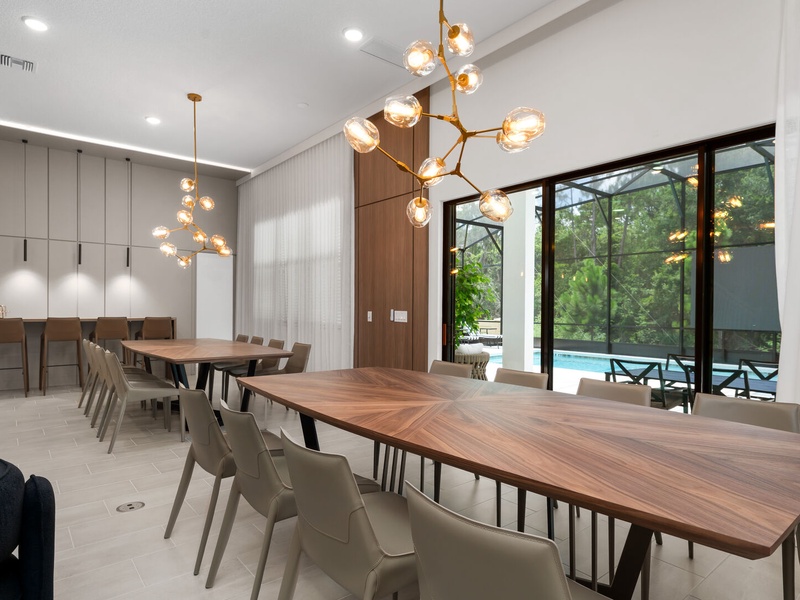 Our dining area features two beautifully designed tables that seat large groups comfortably. You'll also find a convenient bar-height counter with additional seating.