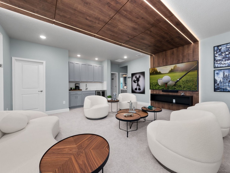 Designed for relaxation and connection, this lounge offers a mini bar area, modern furnishings, and a warm, inviting atmosphere.