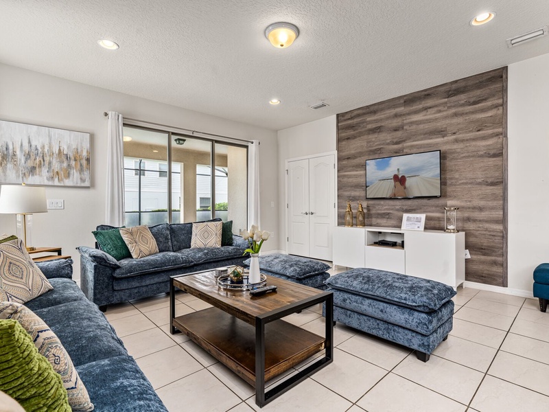 Our living room is equipped with a TV and ample plush seating, perfect for relaxation and entertainment.