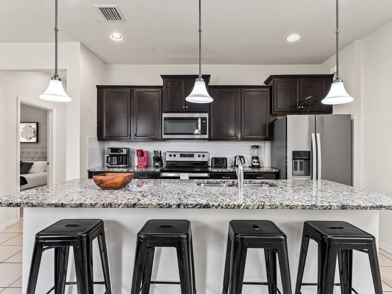 The fully equipped kitchen features stainless steel appliances.