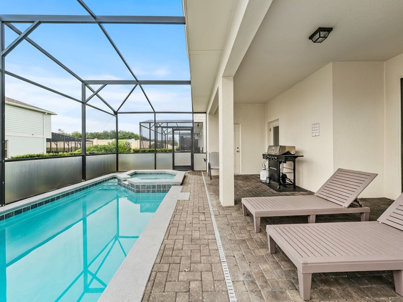 Enjoy the warm Florida sun on the patio, perfect for sunbathing and unwinding by the pool.