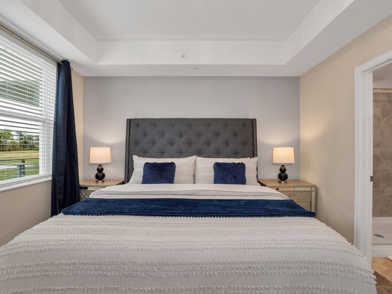 Our master bedroom features a king-size bed, TV, and private bathroom, perfect for relaxing after a long day at the parks.