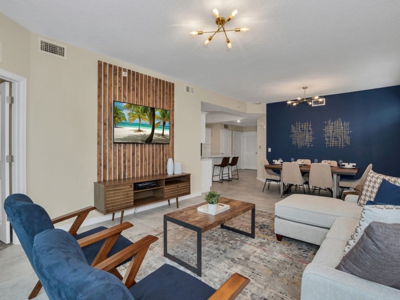 Spacious and comfortable living area with its own flat-screen TV, perfect for spending quality time with family and friends.